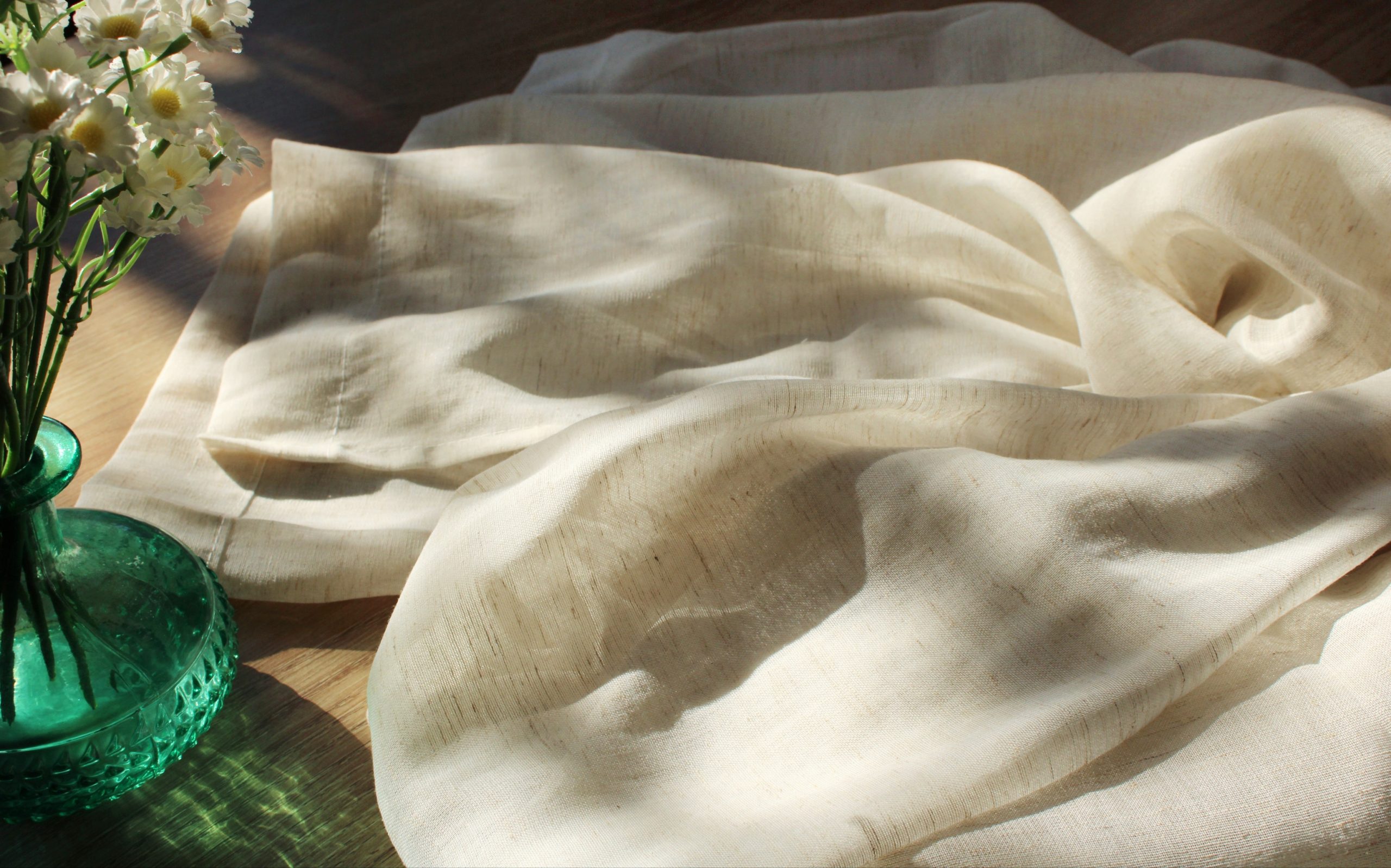 Linen look sheer curtain fabric close up showing the texture of the fabric